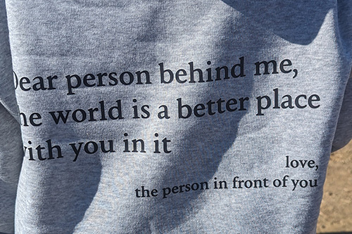 quote on the back of a sweater